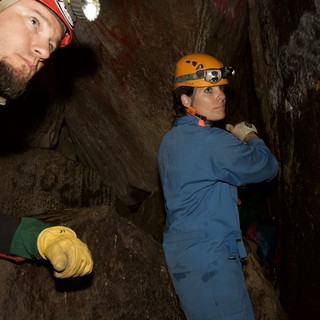 Cavers Navigate Tight Underground Passage Together
