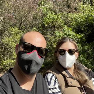 Two People Enjoying Nature while Wearing Masks in the Park