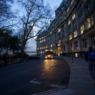 London Bus Passing Grand Building at Dusk