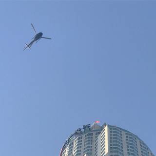Helicopter Flying Over Los Angeles Skyscraper