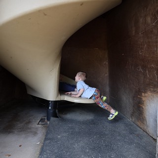 Child Exploring Playground Slide Tunnel Structure