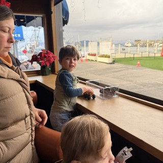 Family Moment at Waterfront Cafe During Winter Holidays