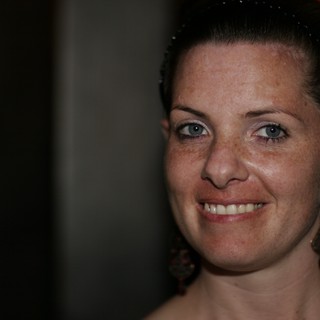 Freckled Woman Smiling Warmly at Evening Event