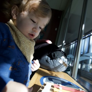 Young Child Playing with Colorful Xylophone at Home