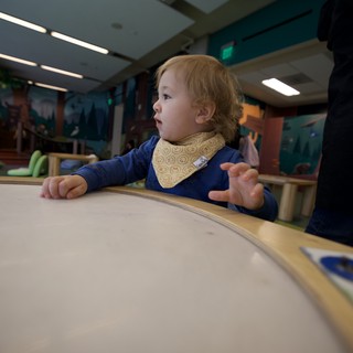 Toddler's Curious Moment at Interactive Learning Table
