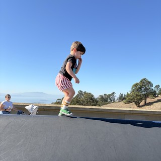 Young Boy Jumping on Outdoor Trampoline in California Hills