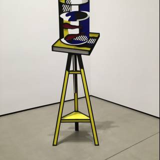 Yellow and Black Art Sculpture with Blue Chair