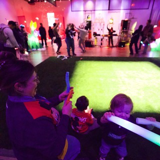 Children Playing with Glow Sticks at Baby Rave Event