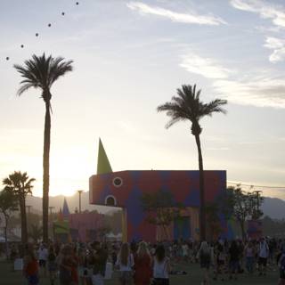 Summer Crowd at Colorful Building Among Palm Trees