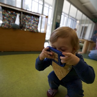 Young Child Taking Photo with Blue Tablet Device