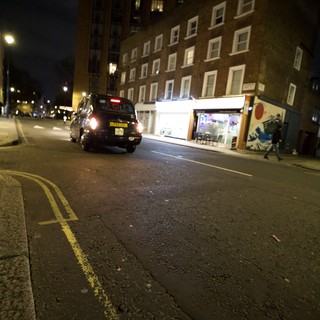 London Black Cab on Rain-Slicked Evening Street