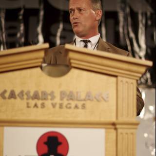 Man delivering a speech at a wooden podium