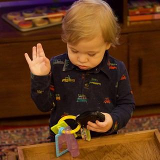 Toddler Concentrated on Toy During Christmas Morning Play
