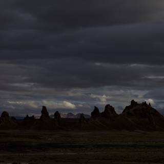 Desert Silhouettes Beneath a Cloudy Sky