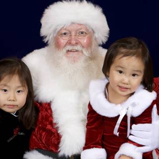 Santa Claus Spreads Christmas Joy with Two Little Girls