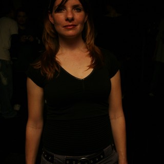 Woman in Black at Dimly Lit Nightclub Event