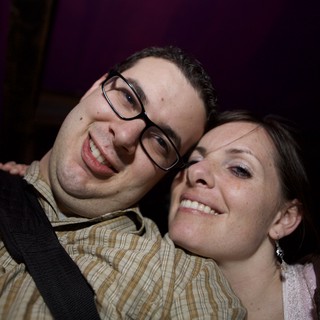 Smiling Couple Poses Together at Nighttime Event