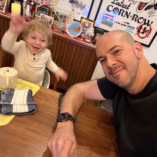 Father and Toddler Sharing Joyful Breakfast Moment at Home
