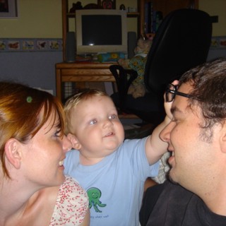 Baby's Curious Gaze Between Loving Parents