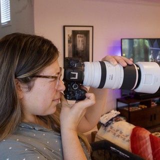 Photographer with Telephoto Lens in Home Studio