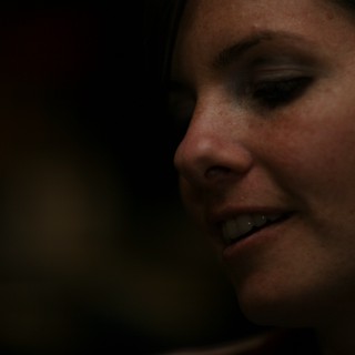 Penelope's Quiet Smile in Dramatic Low Light