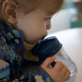 Young Child Peering Through Magnifying Glass in Wonder