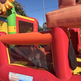 Child Playing in Colorful Inflatable Bounce House