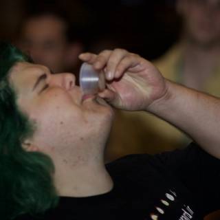 Green-Haired Man Sipping from a Tin Cup