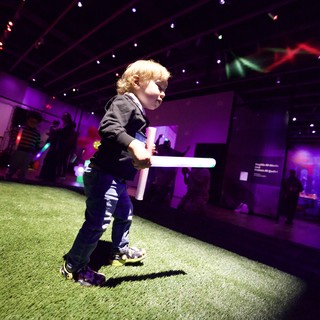 Toddler with Lightsaber at Baby Rave Event