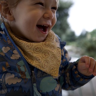 Joyful Toddler in Winter Jacket Outdoors