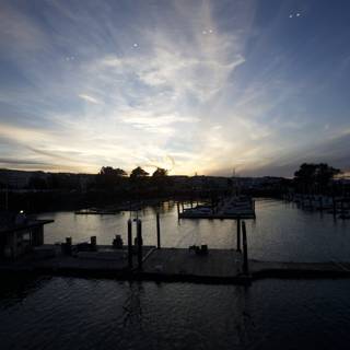 Tranquil Tides: Dock At Dusk Showcasing Sunset's Symphony