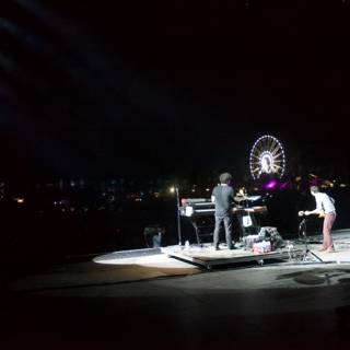Night Performance with Ferris Wheel in the Background