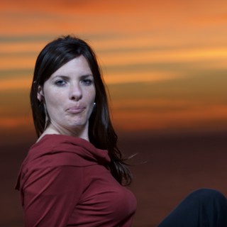 Woman in Red at a Dramatic Sunset Sky