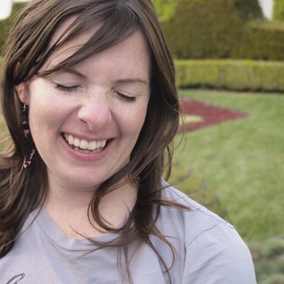 Woman Laughing Joyfully in a Formal Garden