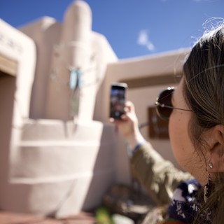 Tourist Photographing Adobe Architecture in Santa Fe