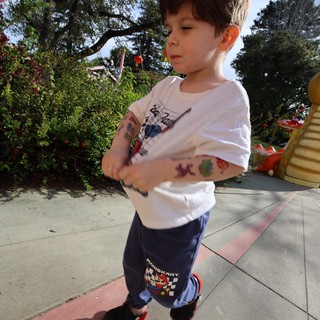 Young Boy with Temporary Tattoos at Outdoor Playground