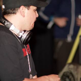 Black-Shirted Man with Baseball Cap and Headphones