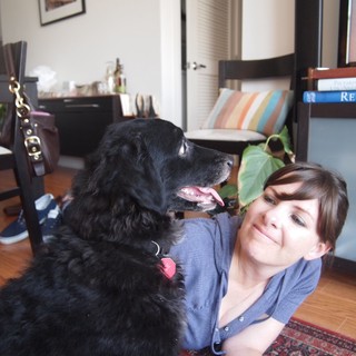 Woman and Her Black Dog Share a Tender Moment