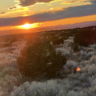 Desert Sunset Over Sagebrush and Distant Mountains
