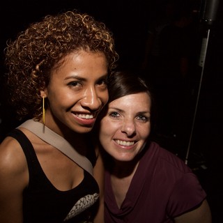 Two Friends Smiling Together at a Nightclub Event