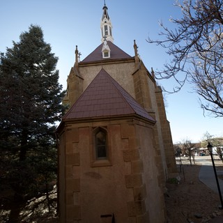 Historic Stone Chapel with Purple Roof and Bell Tower