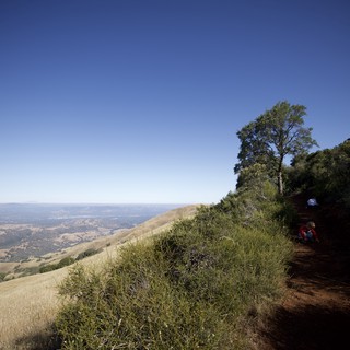 Hikers Resting on Mt. Diablo Trail Above the Valley