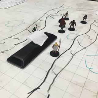 Miniature Warriors Plan Battle Strategies using a Map