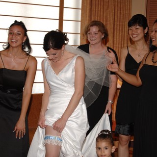Bride Shows Off Her Garter With Bridesmaids