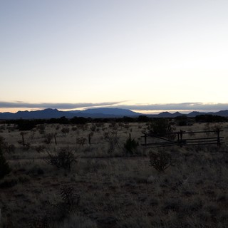 Desert Twilight Over Distant Mountain Ranges