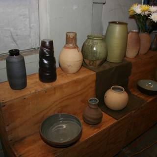 Myriad of Vases on a Wooden Shelf