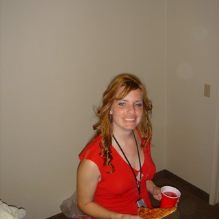 Young Woman Enjoying Pizza and Soda at Party