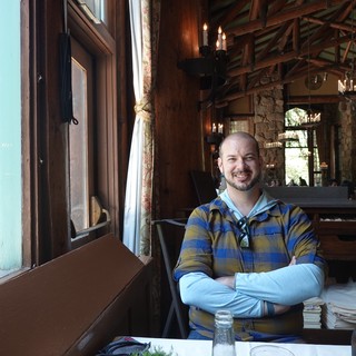 Man Relaxing in Rustic Restaurant Setting