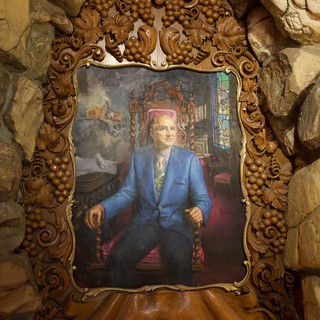 Ornate Portrait in Gilded Frame Against Stone Grotto