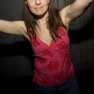 Woman Dancing Freely With Arms Outstretched at Night